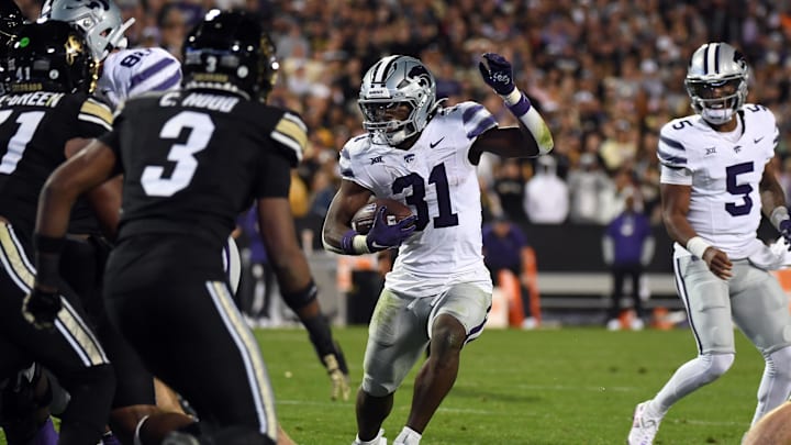 Oct 12, 2024; Boulder, Colorado, USA; Kansas State Wildcats running back DJ Giddens (31) runs for a short gain during the second half against the Colorado Buffaloes at Folsom Field. Mandatory Credit: Christopher Hanewinckel-Imagn Images