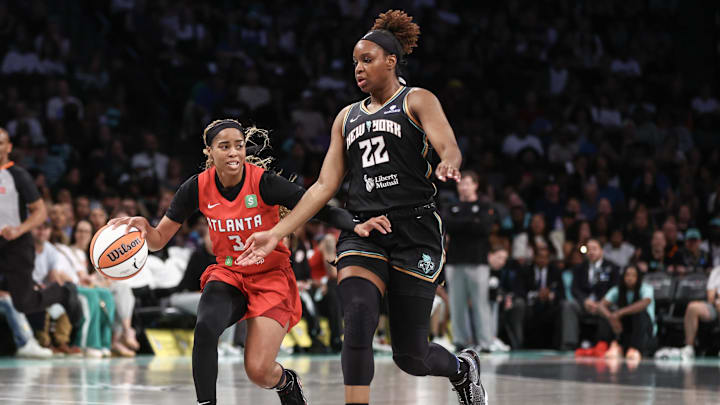 Jul 13, 2025; Brooklyn, New York, USA;  Atlanta Dream guard Jordin Canada (3) looks to drive past New York Liberty forward Kennedy Burke (22) in the second quarter at Barclays Center. Mandatory Credit: Wendell Cruz-Imagn Images