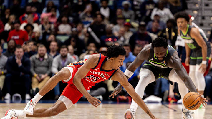 Dec 4, 2025; New Orleans, Louisiana, USA; New Orleans Pelicans forward Trey Murphy III (25) and Minnesota Timberwolves forward/center Julius Randle (30) go for a loose ball during the first half at Smoothie King Center. Mandatory Credit: Stephen Lew-Imagn Images