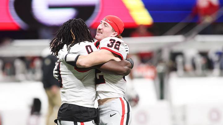 Dec 6, 2025; Atlanta, GA, USA; Georgia Bulldogs running back Roderick Robinson II (0) celebrates with Georgia Bulldogs running back Cash Jones (32) after the game against the Alabama Crimson Tide during the 2025 SEC Championship game at Mercedes-Benz Stadium. Mandatory Credit: Brett Davis-Imagn Images Dec 6, 2025; Atlanta, GA, USA; Georgia Bulldogs running back Roderick Robinson II (0) celebrates with Georgia Bulldogs running back Cash Jones (32) after the game against the Alabama Crimson Tide during the 2025 SEC Championship game at Mercedes-Benz Stadium. Mandatory Credit: Brett Davis-Imagn Images