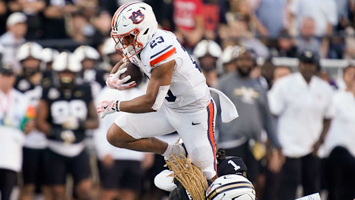 Auburn running back Jeremiah Cobb (23) is stopped by Vanderbilt safety CJ Heard (8) and safety Dontae Carter (1) during the second quarter at FirstBank Stadium in Nashville, Tenn., Saturday, Nov. 8, 2025. Auburn running back Jeremiah Cobb (23) is stopped by Vanderbilt safety CJ Heard (8) and safety Dontae Carter (1) during the second quarter at FirstBank Stadium in Nashville, Tenn., Saturday, Nov. 8, 2025.