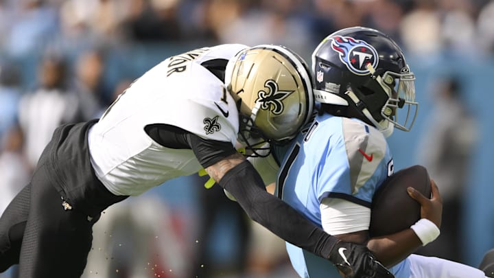 Dec 28, 2025; Nashville, Tennessee, USA; New Orleans Saints cornerback Alontae Taylor (1) tackles Tennessee Titans quarterback Cam Ward (1) during the first quarter of the game at Nissan Stadium. Mandatory Credit: Steve Roberts-Imagn Images Dec 28, 2025; Nashville, Tennessee, USA; New Orleans Saints cornerback Alontae Taylor (1) tackles Tennessee Titans quarterback Cam Ward (1) during the first quarter of the game at Nissan Stadium. Mandatory Credit: Steve Roberts-Imagn Images