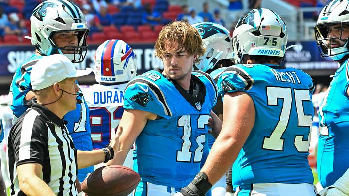 Carolina Panthers quarterback Kenny Pickett (12) hands the ball to a referee Carolina Panthers quarterback Kenny Pickett (12) hands the ball to a referee