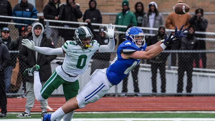 Novi Detroit Catholic Central‘s Jack Janda stretches out but fails to pull in the pass, while being covered by Cass Tech’s Lamont Wilcoxson in the fourth quarter during MHSAA semifinals at Troy Athens high school on Saturday, Nov. 23, 2024.