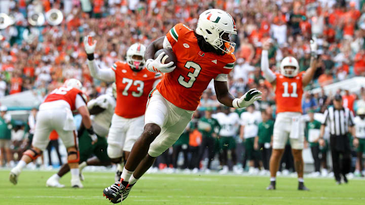 Sep 13, 2025; Miami Gardens, Florida, USA; Miami Hurricanes wide receiver Joshua Moore (3) runs into the end zone for a touchdown against the South Florida Bulls in the first quarter at Hard Rock Stadium. Mandatory Credit: Nathan Ray Seebeck-Imagn Images