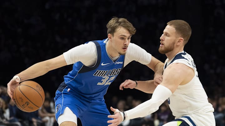 Nov 17, 2025; Minneapolis, Minnesota, USA; Dallas Mavericks forward Cooper Flagg (32) dribbles the ball as Minnesota Timberwolves guard Donte DiVincenzo (0) plays defense in the first half at Target Center. Mandatory Credit: Jesse Johnson-Imagn Images Nov 17, 2025; Minneapolis, Minnesota, USA; Dallas Mavericks forward Cooper Flagg (32) dribbles the ball as Minnesota Timberwolves guard Donte DiVincenzo (0) plays defense in the first half at Target Center. Mandatory Credit: Jesse Johnson-Imagn Images
