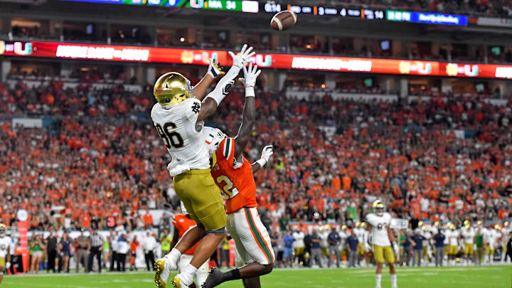 Nov 11, 2017; Miami Gardens, FL, USA; Notre Dame Fighting Irish tight end Alize Mack (86) makes a catch over Miami Hurricanes defensive back Malek Young (12) for a touchdown during the second half at Hard Rock Stadium. Mandatory Credit: Jasen Vinlove-Imagn Images Nov 11, 2017; Miami Gardens, FL, USA; Notre Dame Fighting Irish tight end Alize Mack (86) makes a catch over Miami Hurricanes defensive back Malek Young (12) for a touchdown during the second half at Hard Rock Stadium. Mandatory Credit: Jasen Vinlove-Imagn Images