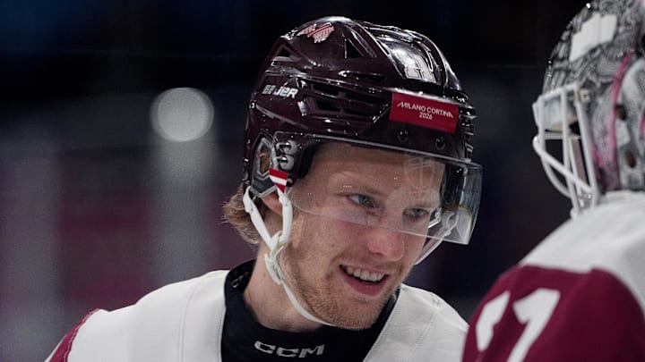 Feb 15, 2026; Milan, Italy; Dans Locmelis of Latvia greets Arturs Silovs of Latvia before their game against Denmark in men's ice hockey group C play during the Milano Cortina 2026 Olympic Winter Games at Milano Rho Ice Hockey Arena. Mandatory Credit: Amber Searls-Imagn Images Feb 15, 2026; Milan, Italy; Dans Locmelis of Latvia greets Arturs Silovs of Latvia before their game against Denmark in men's ice hockey group C play during the Milano Cortina 2026 Olympic Winter Games at Milano Rho Ice Hockey Arena. Mandatory Credit: Amber Searls-Imagn Images