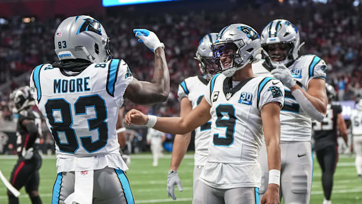 Jan 5, 2025; Atlanta, Georgia, USA; Carolina Panthers quarterback Bryce Young (9) reacts with wide receiver David Moore (83) after running for a touchdown against the Atlanta Falcons during the second half at Mercedes-Benz Stadium. Mandatory Credit: Dale Zanine-Imagn Images