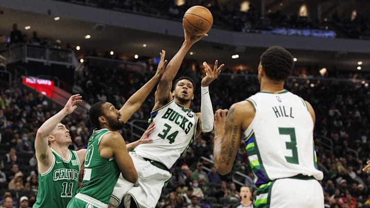 Dec 25, 2021; Milwaukee, Wisconsin, USA; Milwaukee Bucks forward Giannis Antetokounmpo (34) passes the ball under pressure from Boston Celtics forward Jabari Parker (20) during the second quarter at Fiserv Forum. Mandatory Credit: Jeff Hanisch-Imagn Images Dec 25, 2021; Milwaukee, Wisconsin, USA; Milwaukee Bucks forward Giannis Antetokounmpo (34) passes the ball under pressure from Boston Celtics forward Jabari Parker (20) during the second quarter at Fiserv Forum. Mandatory Credit: Jeff Hanisch-Imagn Images