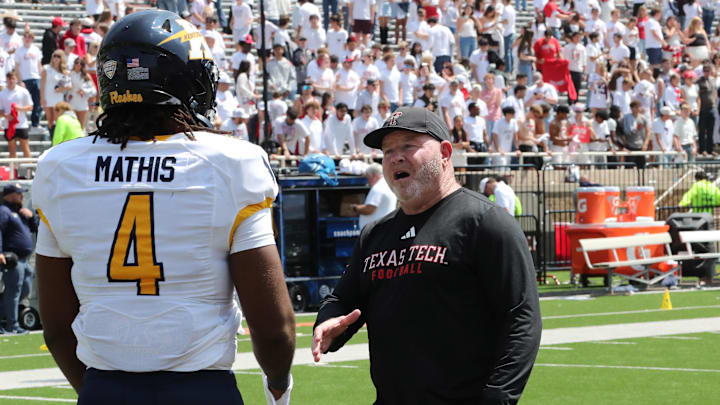 Sep 6, 2025; Lubbock, Texas, USA;  Texas Tech Red Raiders associate head coach Kenny Perry visits with Kent State Golden Flashes defensive end Jamond Mathis (4) after the game at Jones AT&T Stadium. Mandatory Credit: Michael C. Johnson-Imagn Images