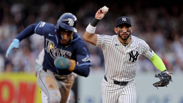 May 22, 2026; Bronx, New York, USA; Tampa Bay Rays left fielder Chandler Simpson (14) runs to third during a rundown after being picked off at second base as New York Yankees shortstop Jose Caballero (72) chases during the first inning at Yankee Stadium. Mandatory Credit: Brad Penner-Imagn Images