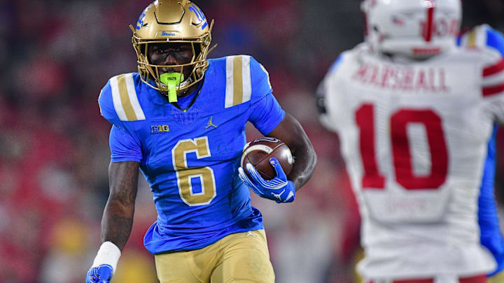 Nov 8, 2025; Pasadena, California, USA; UCLA Bruins running back Anthony Woods (6) runs the ball against the Nebraska Cornhuskers during the second half at the Rose Bowl. Mandatory Credit: Gary A. Vasquez-Imagn Images