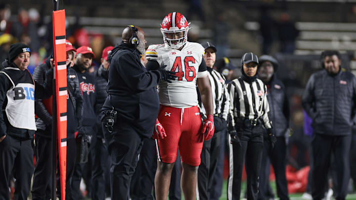 Nov 25, 2023; Piscataway, New Jersey, USA; Maryland Terrapins defensive lineman Dillan Fontus (46) talks with head coach Mike Locksley after being ejected for targeting during the second half against the Rutgers Scarlet Knights at SHI Stadium. Mandatory Credit: Vincent Carchietta-Imagn Images