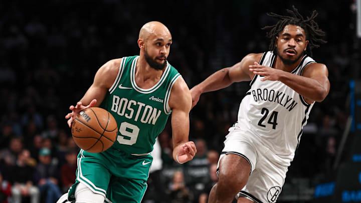 Nov 13, 2024; Brooklyn, New York, USA; Boston Celtics guard Derrick White (9) drives to the basket as Brooklyn Nets guard Cam Thomas (24) defends during the first quarter at Barclays Center. Mandatory Credit: Vincent Carchietta-Imagn Images