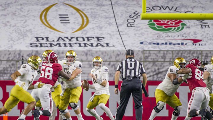 Jan 1, 2021; Arlington, TX, USA; Notre Dame s Ian Book (12) looks to throw downfield during the 2021 College Football Playoff Rose Bowl game on Friday, Jan. 1, 2021, inside AT&T Stadium in Arlington, Texas. Jan 1, 2021; Arlington, TX, USA; Notre Dame s Ian Book (12) looks to throw downfield during the 2021 College Football Playoff Rose Bowl game on Friday, Jan. 1, 2021, inside AT&T Stadium in Arlington, Texas.