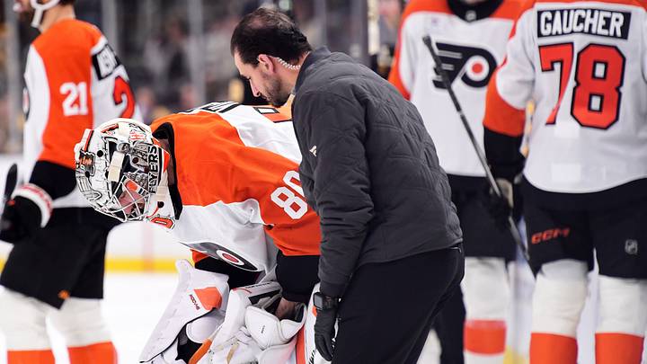 Sep 22, 2026; Boston, Massachusetts, USA;  Philadelphia Flyers goaltender Dan Vladar (80) is checked by a member of the training staff during the first period against the Boston Bruins at TD Garden.