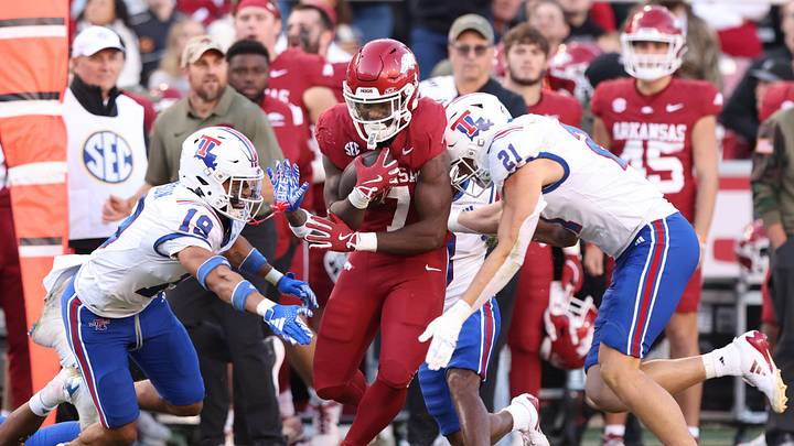 Nov 23, 2024; Fayetteville, Arkansas, USA; Arkansas Razorbacks running back Rashod DuBinion (7) rushes in the second quarter as Louisiana Tech Bulldogs defensive back Roderick Roberson (19) and linebacker Zach Limos (21) defend at Donald W. Reynolds Razorback Stadium. Mandatory Credit: Nelson Chenault-Imagn Images Nov 23, 2024; Fayetteville, Arkansas, USA; Arkansas Razorbacks running back Rashod DuBinion (7) rushes in the second quarter as Louisiana Tech Bulldogs defensive back Roderick Roberson (19) and linebacker Zach Limos (21) defend at Donald W. Reynolds Razorback Stadium. Mandatory Credit: Nelson Chenault-Imagn Images