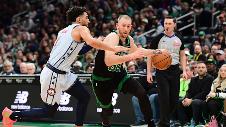 Apr 6, 2025; Boston, Massachusetts, USA; Boston Celtics forward Sam Hauser (30) controls the ball while Washington Wizards guard Colby Jones (1) defends during the second half at TD Garden. Mandatory Credit: Bob DeChiara-Imagn Images
