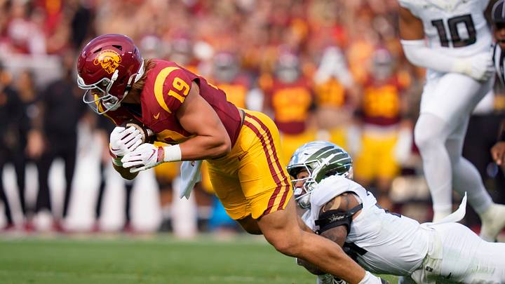 Oregon defensive back Aaron Flowers brings down USC tight end Mark Bowman as the Oregon Ducks face the USC Trojans on Sept. 26, 2026, at Los Angeles Memorial Coliseum in Los Angeles, California.