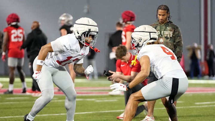 Ohio State Buckeyes cornerbacks Bryce West (12) and Devin Sanchez (4) complete a drill during spring football practice at the Woody Hayes Athletic Center in Columbus on March 17, 2025.