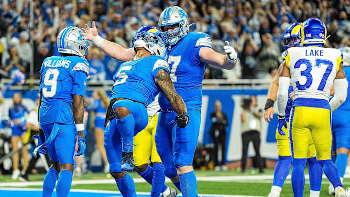 Detroit Lions running back David Montgomery celebrates his winning 1-yard touchdown run to defeat the Los Angeles Rams, 26-20, during overtime at Ford Field in Detroit on Sunday, Sept. 8, 2024. Lions receiver Jameson Williams and center Frank Ragnow also are fired up.