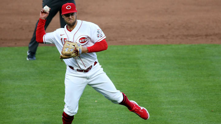 Cincinnati Reds second baseman Nick Senzel (15) throws to first base after fielding a ground ball.