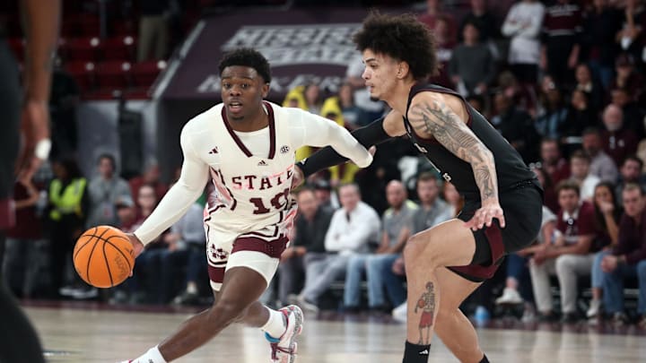 Feb 25, 2023; Starkville, Mississippi, USA; Mississippi State Bulldogs guard Dashawn Davis (10) dribbles as Texas A&M Aggies forward Andersson Garcia (11) defends during the first half at Humphrey Coliseum. Mandatory Credit: Petre Thomas-Imagn Images