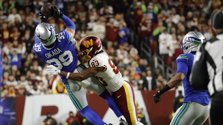 Nov 2, 2025; Landover, Maryland, USA; Seattle Seahawks safety Ty Okada (39) makes a pass interception against Washington Commanders wide receiver Jaylin Lane (83) during the first half at Northwest Stadium. Mandatory Credit: Amber Searls-Imagn Images Nov 2, 2025; Landover, Maryland, USA; Seattle Seahawks safety Ty Okada (39) makes a pass interception against Washington Commanders wide receiver Jaylin Lane (83) during the first half at Northwest Stadium. Mandatory Credit: Amber Searls-Imagn Images