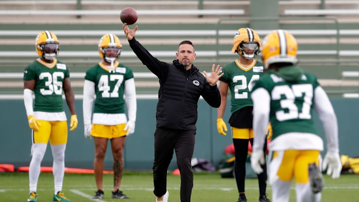 Green Bay Packers head coach Matt LaFleur throws the the ball to cornerback Johnathan Baldwin during individual drills.