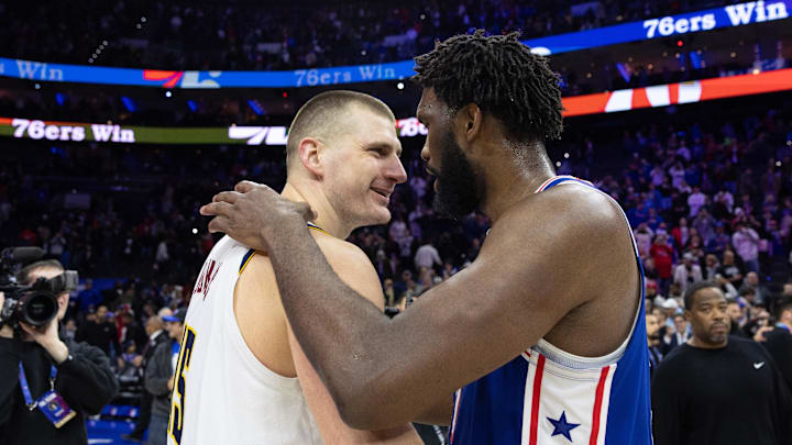 Jan 16, 2024; Philadelphia, Pennsylvania, USA; Philadelphia 76ers center Joel Embiid (21) hugs and talks with Denver Nuggets center Nikola Jokic (15) after the game at Wells Fargo Center. Mandatory Credit: Bill Streicher-Imagn Images