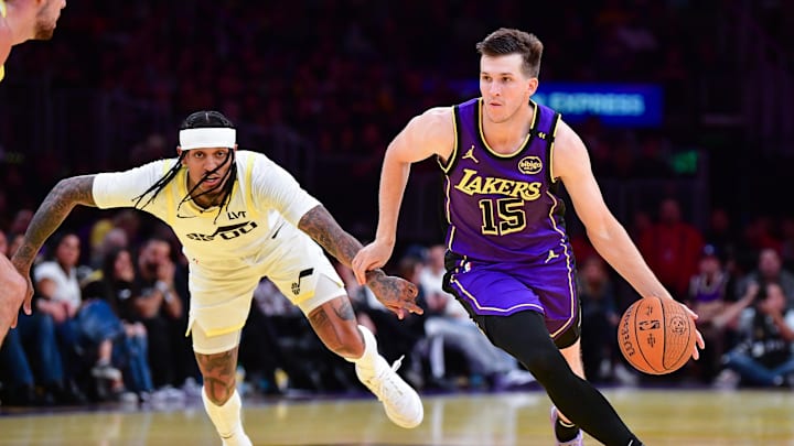 Nov 19, 2024; Los Angeles, California, USA; Los Angeles Lakers guard Austin Reaves (15) moves the ball against Utah Jazz guard Jordan Clarkson (00) during the first half at Crypto.com Arena. Mandatory Credit: Gary A. Vasquez-Imagn Images Nov 19, 2024; Los Angeles, California, USA; Los Angeles Lakers guard Austin Reaves (15) moves the ball against Utah Jazz guard Jordan Clarkson (00) during the first half at Crypto.com Arena. Mandatory Credit: Gary A. Vasquez-Imagn Images
