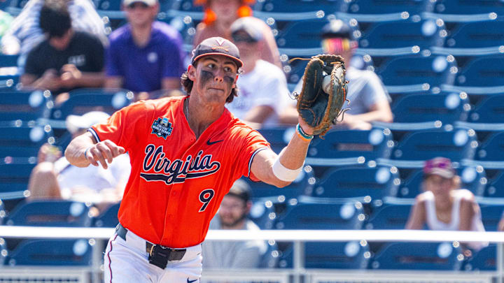 Jun 16, 2024; Omaha, NE, USA; Virginia Cavaliers first baseman Henry Ford (9) gets an out against the Florida State Seminoles during the seventh inning at Charles Schwab Field Omaha. Mandatory Credit: Dylan Widger-Imagn Images