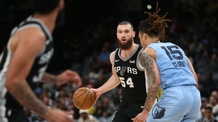 Apr 9, 2024; Memphis, Tennessee, USA; San Antonio Spurs forward Sandro Mamukelashvili (54) dribbles as Memphis Grizzlies forward Brandon Clarke (15) defends during the second half at FedExForum. 
