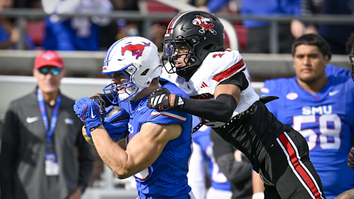 Nov 22, 2025; Dallas, Texas, USA; SMU Mustangs tight end Matthew Hibner (88) is tackled  by Louisville Cardinals defensive back Corey Gordon (24) during the first half at Gerald J. Ford Stadium. Mandatory Credit: Jerome Miron-Imagn Images