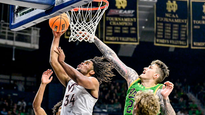 Feb 8, 2025; South Bend, Indiana, USA; Virginia Tech Hokies forward Mylyjael Poteat (34) goes up for a shot as Notre Dame Fighting Irish forward Nikita Konstantynovskyi (25) defends in the second half at the Purcell Pavilion. Mandatory Credit: Matt Cashore-Imagn Images
