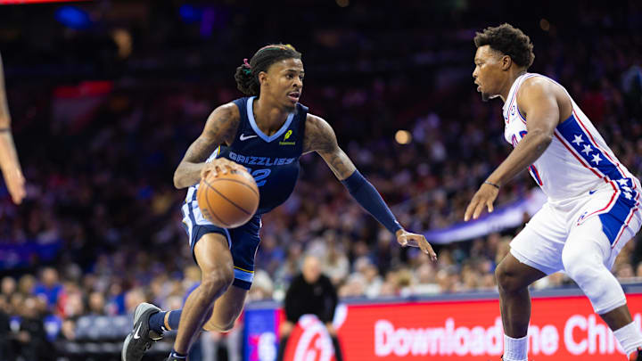Nov 2, 2024; Philadelphia, Pennsylvania, USA; Memphis Grizzlies guard Ja Morant (12) drives against Philadelphia 76ers guard Kyle Lowry (7) during the third quarter at Wells Fargo Center. Mandatory Credit: Bill Streicher-Imagn Images