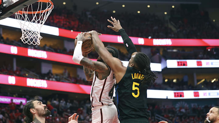 May 4, 2025; Houston, Texas, USA; Golden State Warriors forward Kevon Looney (5) defends as Houston Rockets guard Jalen Green (4) attempts to score during game seven of the first round for the 2025 NBA Playoffs at Toyota Center. Mandatory Credit: Troy Taormina-Imagn Images