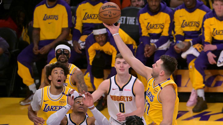 Luka Doncic takes it to the basket against the Denver Nuggets. 