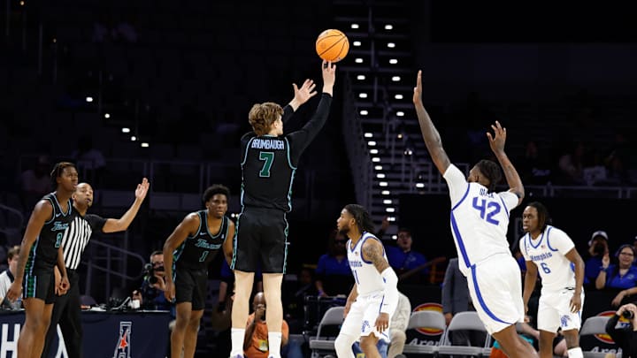 Mar 15, 2025; Fort Worth, TX, USA; Tulane Green Wave guard Rowan Brumbaugh (7) scores a three-point basket against Memphis Tigers forward Dain Dainja (42) during the first half at Dickies Arena. Mandatory Credit: Chris Jones-Imagn Images Mar 15, 2025; Fort Worth, TX, USA; Tulane Green Wave guard Rowan Brumbaugh (7) scores a three-point basket against Memphis Tigers forward Dain Dainja (42) during the first half at Dickies Arena. Mandatory Credit: Chris Jones-Imagn Images
