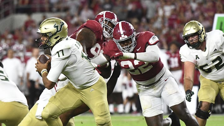 Sep 7, 2024; Tuscaloosa, Alabama, USA;  South Florida Bulls quarterback Byrum Brown (17) rolls away from Alabama Crimson Tide defensive lineman LT Overton (22) at Bryant-Denny Stadium. Alabama won 42-16. Mandatory Credit: Gary Cosby Jr.-Imagn Images