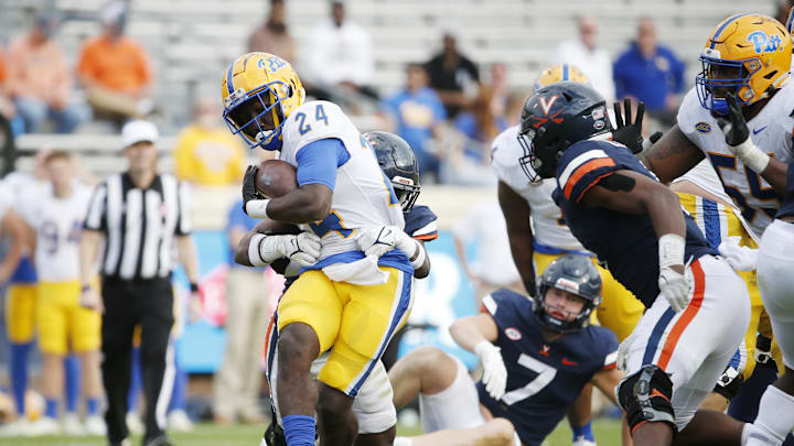 Nov 12, 2022; Charlottesville, Virginia, USA; Pittsburgh Panthers running back C'Bo Flemister (24) carries the ball as Virginia Cavaliers defensive end Terrell Jones (25) defends during the second half at Scott Stadium. Mandatory Credit: Amber Searls-Imagn Images