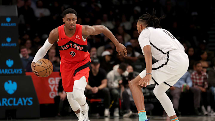 Mar 26, 2025; Brooklyn, New York, USA; Toronto Raptors guard RJ Barrett (9) brings the ball up court against Brooklyn Nets forward Ziaire Williams (8) during the fourth quarter at Barclays Center. Mandatory Credit: Brad Penner-Imagn Images