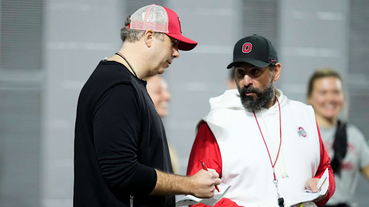 Ohio State Buckeyes offensive coordinator Arthur Smith, left, talks to defensive coordinator Matt Patricia during the first day of spring workouts for the 2026 football season at Woody Hayes Athletic Complex in Columbus on March 10, 2026.