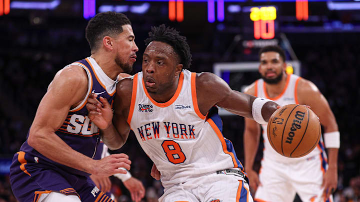 New York Knicks forward OG Anunoby dribbles against Phoenix Suns guard Devin Booker during the second half at Madison Square Garden. Mandatory Credit: Vincent Carchietta-Imagn Images
