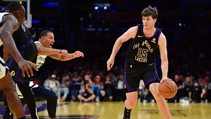 Nov 14, 2023; Los Angeles, California, USA; Los Angeles Lakers guard Austin Reaves (15) moves the ball as forward Anthony Davis (3) provides coverage against Memphis Grizzlies guard Desmond Bane (22) during the first half at Crypto.com Arena. Mandatory Credit: Gary A. Vasquez-Imagn Images