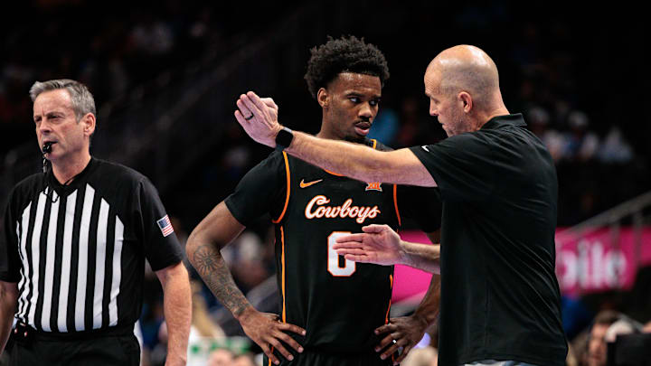 Mar 11, 2026; Kansas City, MO, USA; Oklahoma State Cowboys coach Steve Lutz speaks with Oklahoma State Cowboys guard Jaylen Curry (0) during the first half against the TCU Horned Frogs at T-Mobile Center. Mandatory Credit: William Purnell-Imagn Images
