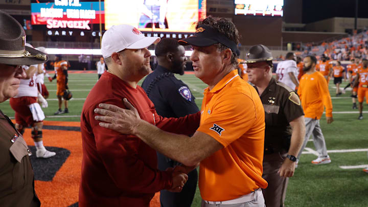 Stillwater, Oklahoma, USA; Oklahoma State coach Mike Gundy, right, talks with South Alabama coach Kane Wommack after an NCAA football game between Oklahoma State and South Alabama at Boone Pickens Stadium. South Alabama won 33-7. 