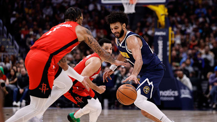 Jan 15, 2025; Denver, Colorado, USA; Houston Rockets forward Cam Whitmore (7) steals the ball away from Denver Nuggets guard Jamal Murray (27) as guard Fred VanVleet (5) defends in the third quarter at Ball Arena. Mandatory Credit: Isaiah J. Downing-Imagn Images