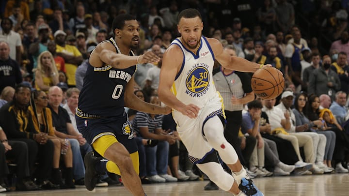 May 3, 2022; Memphis, Tennessee, USA; Golden State Warriors guard Stephen Curry (30) drives to the basket as Memphis Grizzlies guard De'Anthony Melton (0) defends during the second half during game two of the second round for the 2022 NBA playoffs at FedExForum. Mandatory Credit: Petre Thomas-USA TODAY Sports